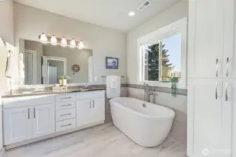 Large soaking tub, still with those western views  out the large window. Ample storage with linen closet and large vanity