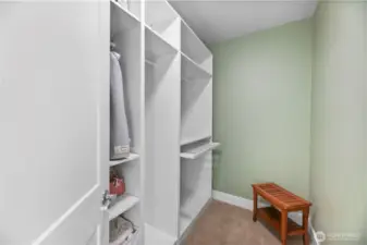 Custom walk-in closet off the primary hallway that also leads to a jack and jill bathroom.