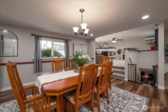 3 steps up to the living room and a few steps down to the bonus room with fireplace. Open concept living at its best.