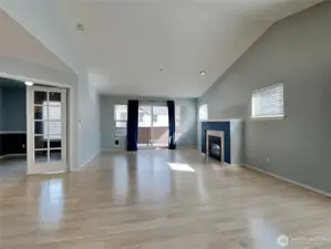 Living room, showing first bedroom off to the left with french doors