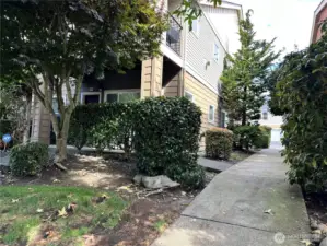 Side of building with beautiful landscaping and safe sidewalks