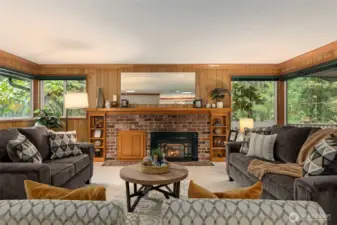 Cozy gas fireplace with brick surround and built-ins