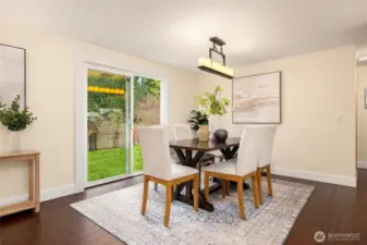 Large glass sliding doors lead to fenced back yard.