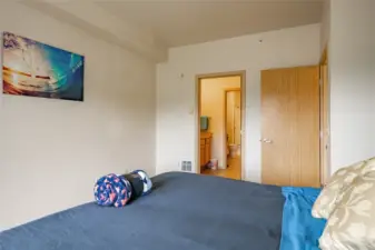 Primary bedroom with en suite and sliding door to balcony