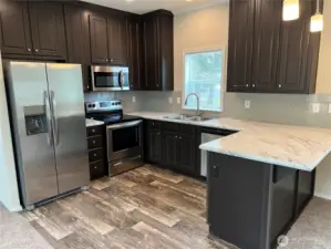 Nice sized kitchen with plenty of cabinet space and an eating bar too.