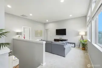 Spacious upstairs loft or bonus area perfect for a second living room, media space, or playroom.