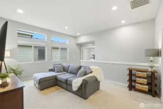 Large flexible loft space ideal for entertaining, relaxing, or creating a secondary gathering area.