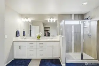 Luxury primary bathroom featuring dual vanities, glass walk-in shower, modern finishes, and spa-like design in this Black Diamond WA home.