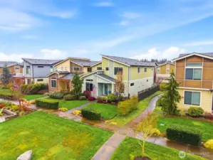 Neighborhood green space with landscaped paths and open areas perfect for outdoor activities and play.