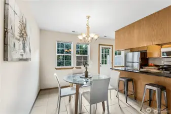 Dining room off of kitchen area with additional seating at counter.