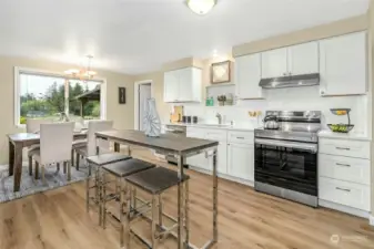 Updated kitchen with new white cabinetry, quartz counter and high quality stainless steel appliances.