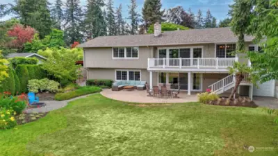 Drone view of the back yard with the fire pit showcasing all that this home has to offer.