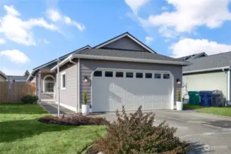 Welcome Home! 2-Car attached garage with large driveway. Windows in garage door create natural light. Flag Pole in front. A nice feature to note regarding garage is furnace & water heater are not located inside creating more space for vehicles & storage . Note Covered exterior entrance at front entrance.