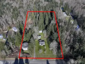 The property is screened with trees on three sides.  The round concrete structure is one of the Lagoon Point Community wells so there is an easement for well access and maintenance to that structure.