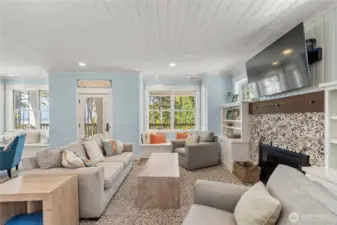 Main level living room with wood burning fireplace & built-ins
