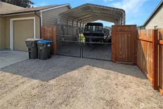 The large carport pulls right into the backyard!