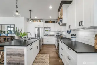 Beautifully appointed kitchen with granite counter tops, farm sink and high end finishes.