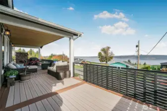 This is a DECK!  Running the length of the house, it has room for relaxing, cooking, and entertaining.