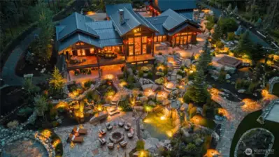 Lush, mature gardens and landscape lighting that transform the grounds by night