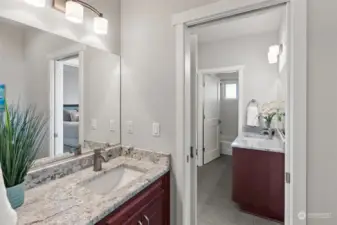 The lower level full bathroom conveniently sits between both lower level bedrooms. A separate water closet with sink can be closed off from the shower area for privacy.