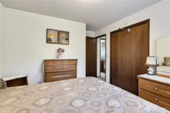 Second bedroom showing the doors to the closet.  Thats the shared bathroom across the hall