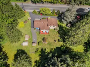 Aerial shot showing the house with all the outbuildings, driveways and that bear in the yard(!)