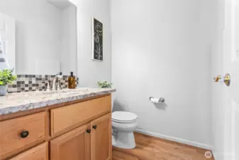 Guest bath on main floor in addition the the primary bath suite and a full bath upstairs.