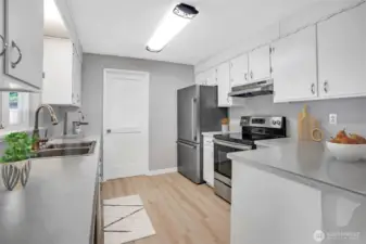 Decorative overhead lighting shines over the kitchen space.