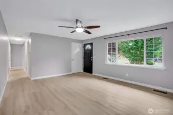 Large picture window floods the room with natural light.