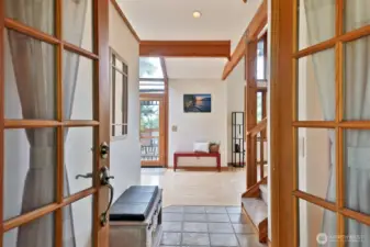 Let's go inside. Straight ahead to your kitchen/living area, Immediately to your right is a hallway that leads to two bedrooms, a full bath, a closet with the washer & dryer and the stairs to the lower level. Stairs to the upper level are on the right.