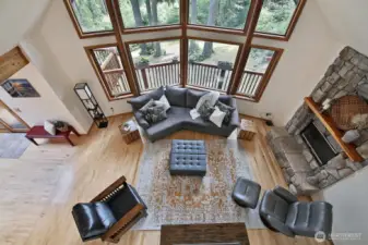 We are now on the upper level (Primary Suite #1) looking upon the open living room. Look outside and you get a sense of the generous yard.