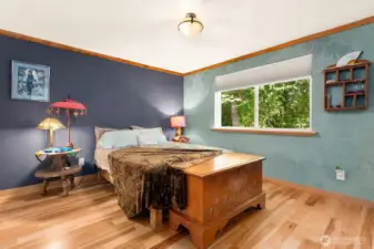 The primary bedroom has beautiful natural clay plaster and wood trim.