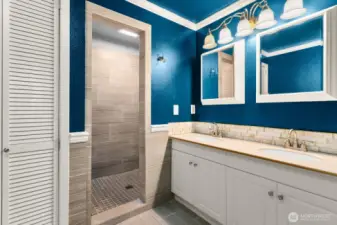 The primary bath has beautiful stonework details.