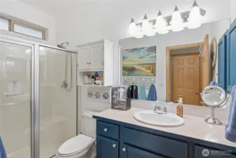 Spacious primary bathroom with modern fixtures and plenty of natural light. Bath