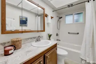 The full bath features upgraded fixtures, a privacy window and security bar in the shower.