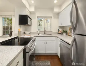 Quartz counters, soft-close cabinets, induction oven, newer SS appliances