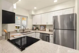 Quartz counters, soft-close cabinets, induction oven, newer SS appliances