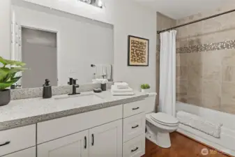 Primary ensuite with large vanity and full bath.