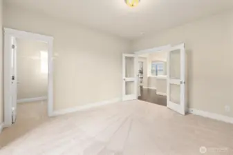 Bedroom on main with french doors with acces to backyard