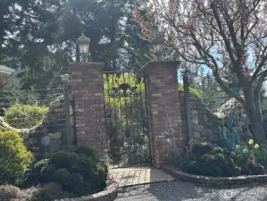 Stately brick and wrought iron gated entry
