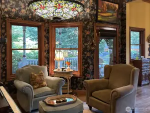 Sitting room off the kitchen and great room overlooking the covered patio and gardens