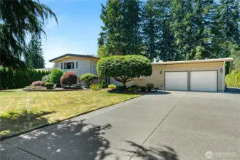 Beautifully maintained home and manicured property. with two car garage and huge shop out back.