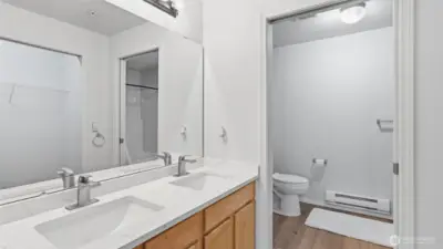 This well-appointed primary ensuite offers dual vanities & the convenience of a separate water closet.