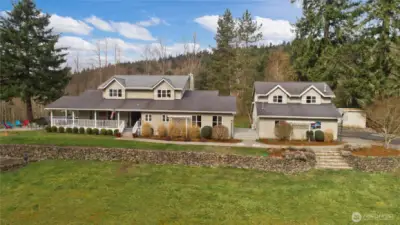 Front exterior of the home with detached 3-car garage and ADU above.