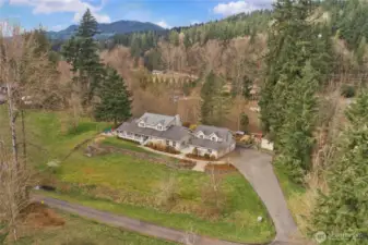 Aerial view showing the home set on 1.77 acres surrounded by nature.