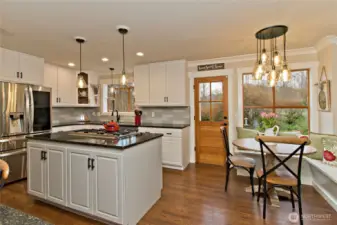 Kitchen and dining area with built-in nook seating.