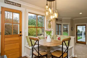 Dining nook with built-in seating and garden views.