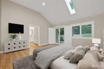 Spacious primary bedroom with shutter-covered door to exterior patio.