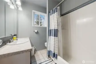 Full bathroom with tile flooring.