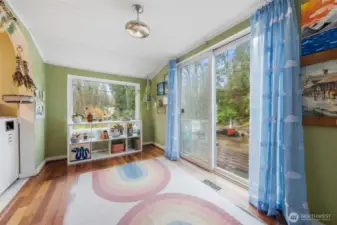The large window and the sliding glass door provide this room with an abundance of natural light making this room light and bright.